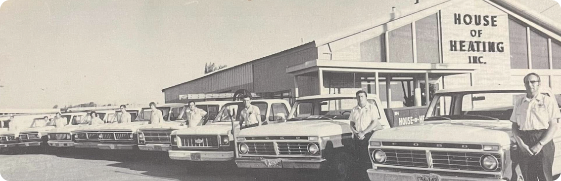 Company photo of vintage cars and building